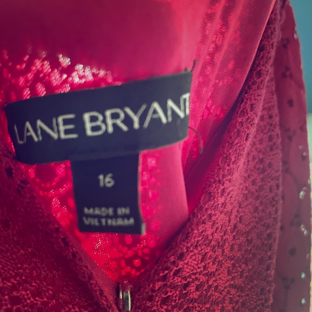 Red short sleeve a little below the knee dress .